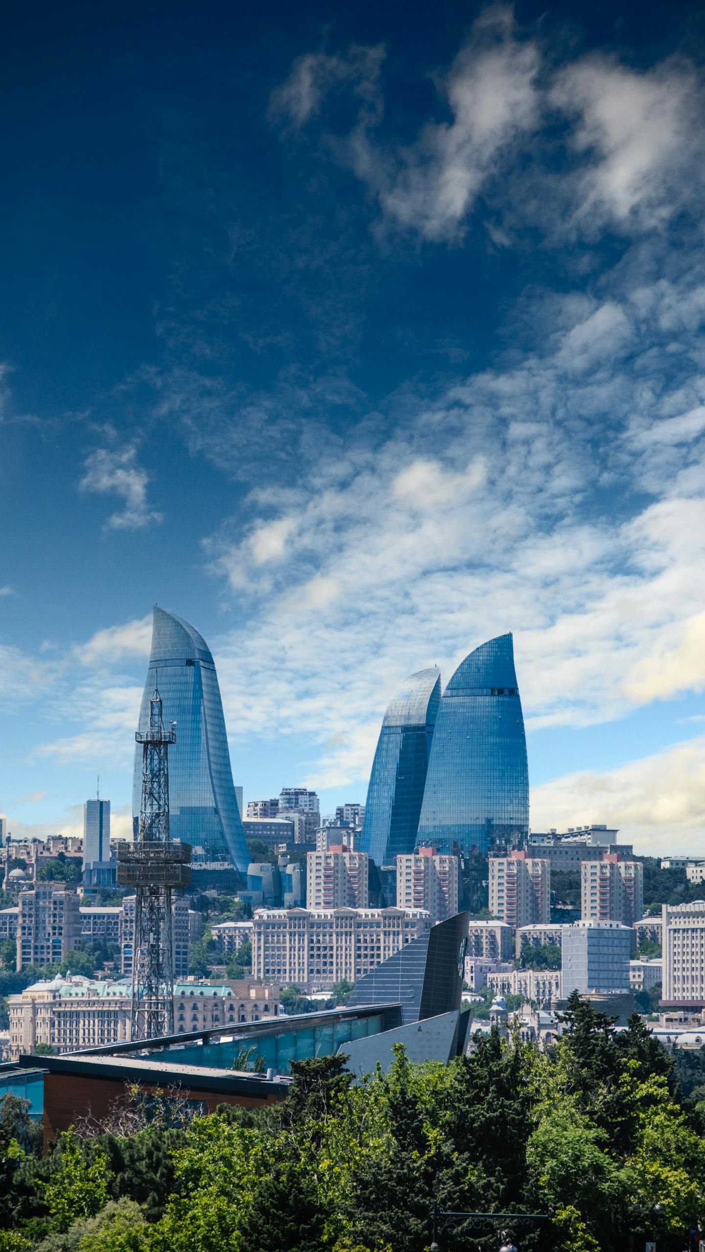 Stunning view of Baku's skyline featuring the iconic Flame Towers on a cloudy day.